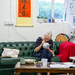 Rhian Malin decorating a mandala bottle in her workshop 2019